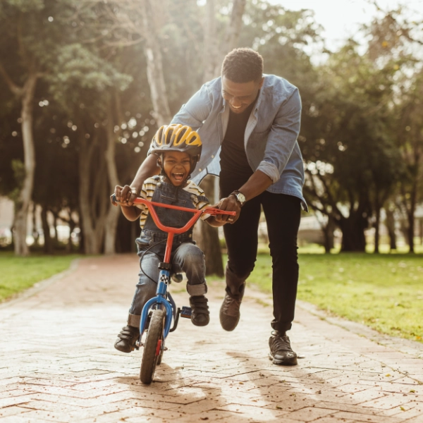 Father Teaching Son To Ride Bike 600X600