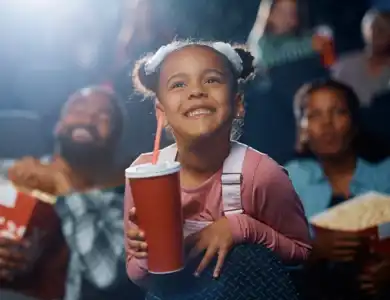 Little Girl At The Movies With Mom And Dad 600X600