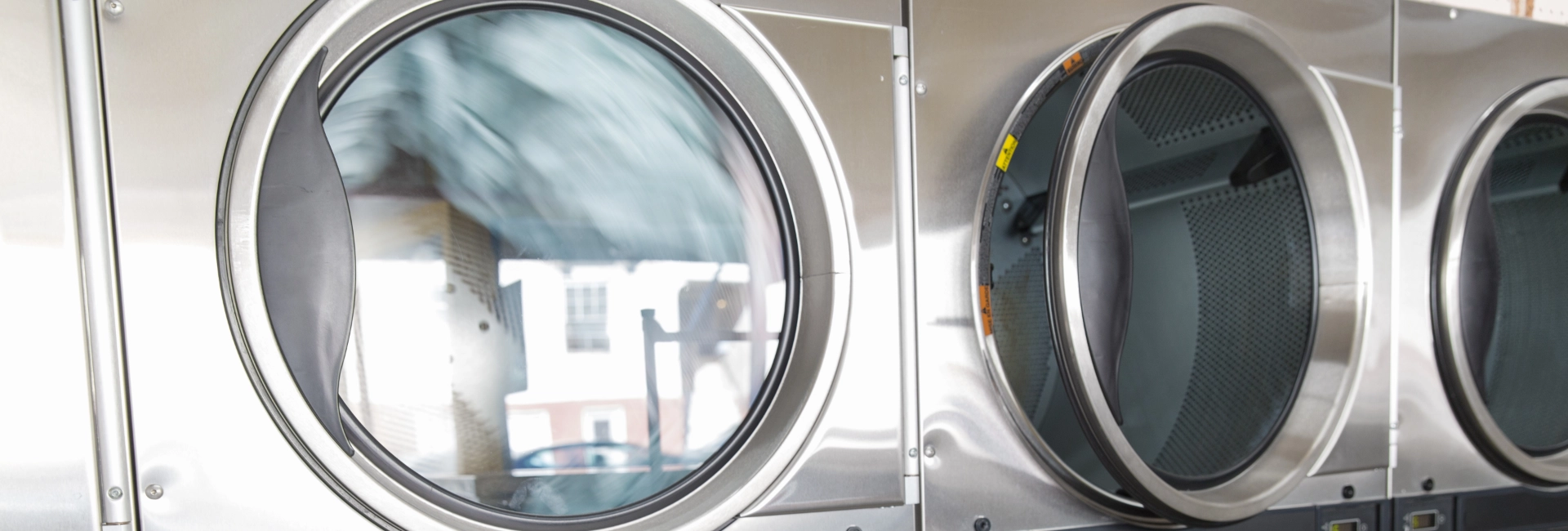 Dryers Spinning At Laundromat 1920X650